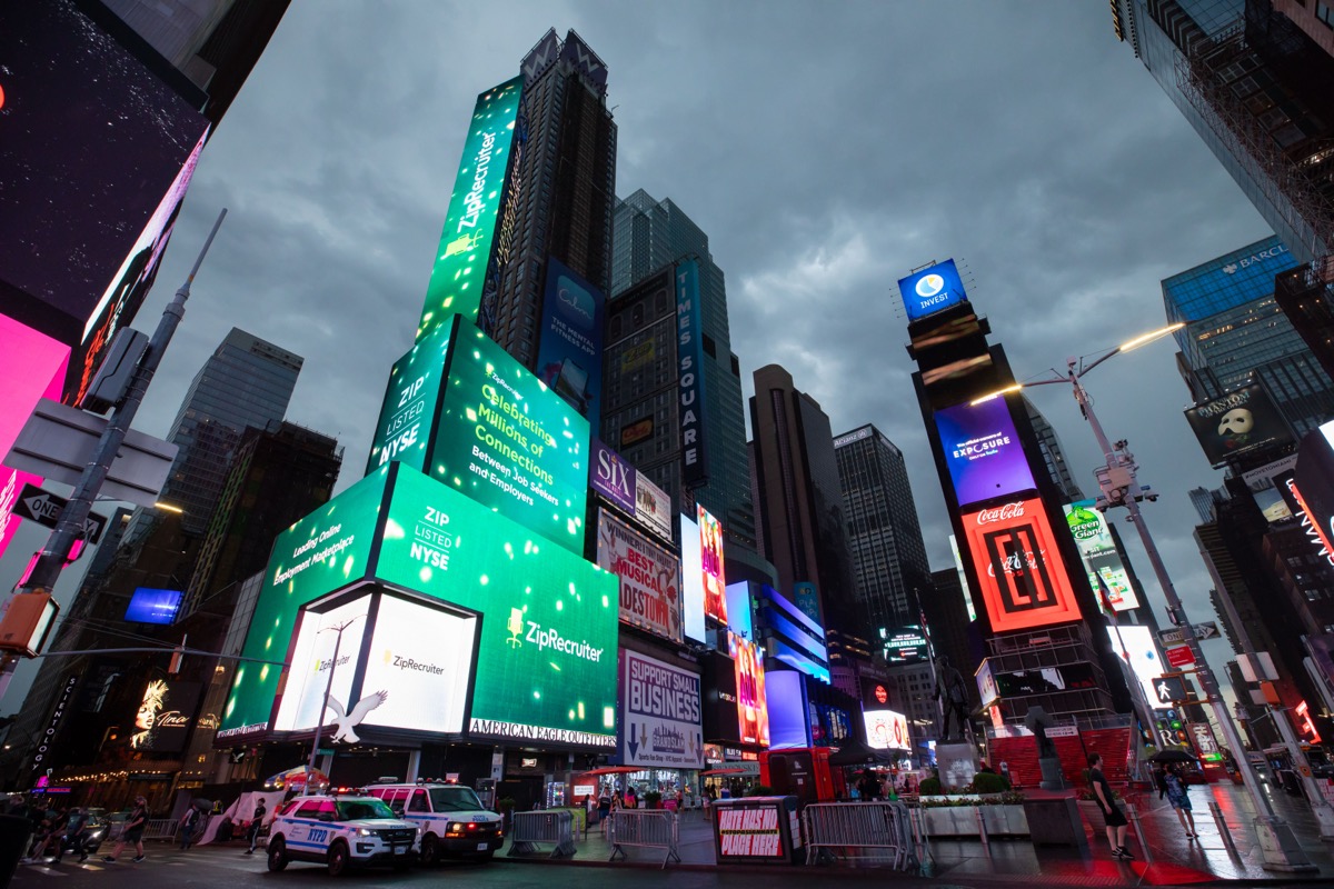 ZipRecruiter green tower towering over Times Square at dusk