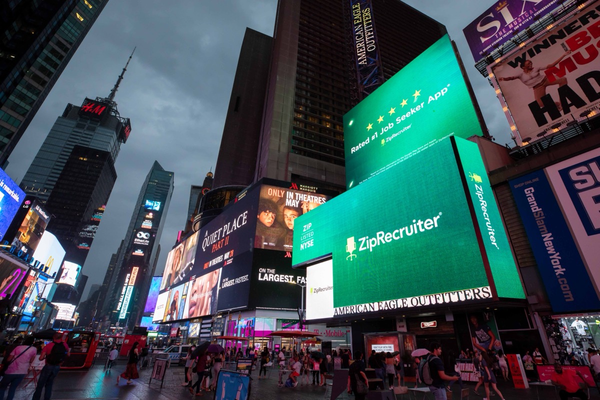 ZipRecruiter billboard lighting up Times Square at night